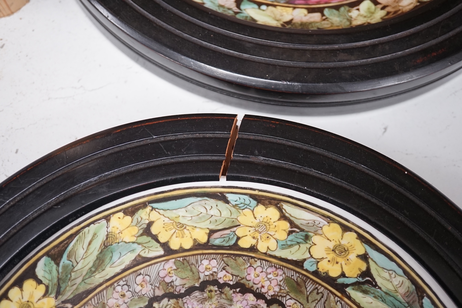 A set of four Copeland Spode Aesthetic period, outside decorated four seasons portrait plates, circa 1880, housed in ebonised wood frames, overall 31cm in diameter. Condition - fair, three frames cracked